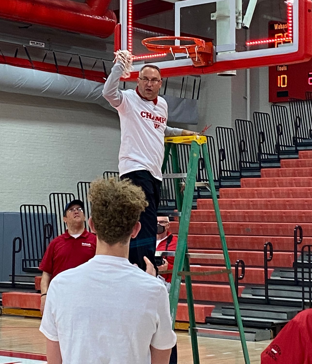 Wabash Coach Kyle Brumett cuts down the nets after the Little Giants were crowned the champions of the North Coast Athletic Conference.